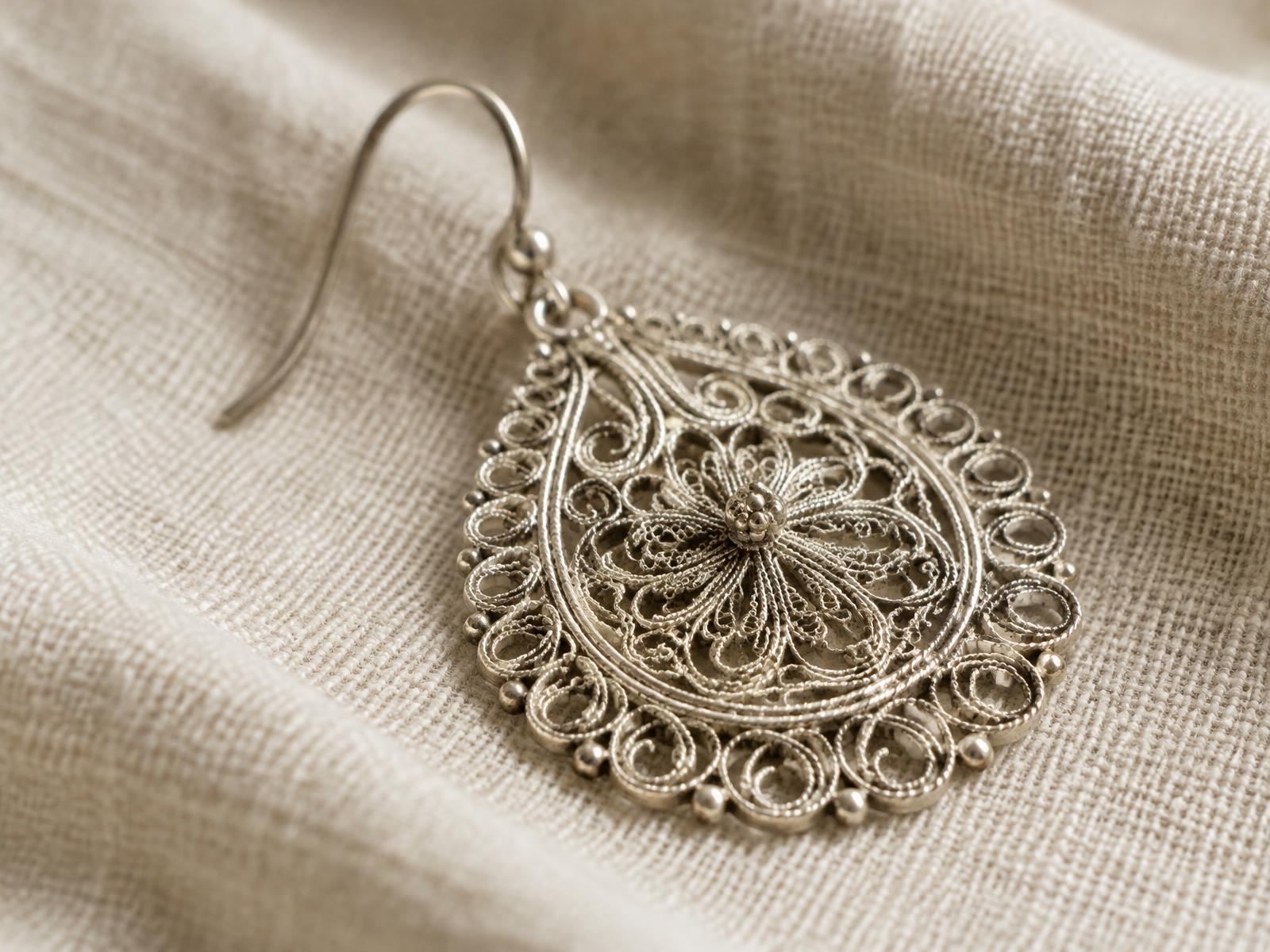 Handcrafted silver filigree on ivory linen